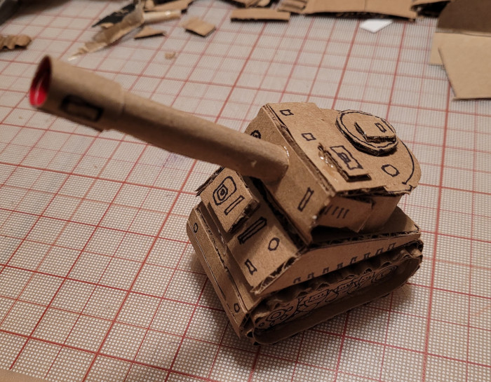 small cardboard tank front angle with red label showing inside barrel