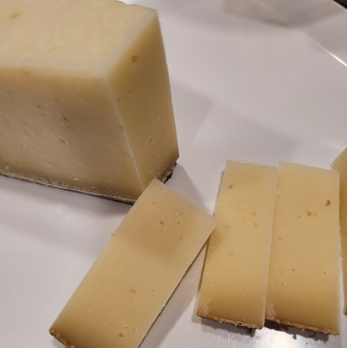 Photo of slices of Grand Cru showing dark rind and off-white paste.